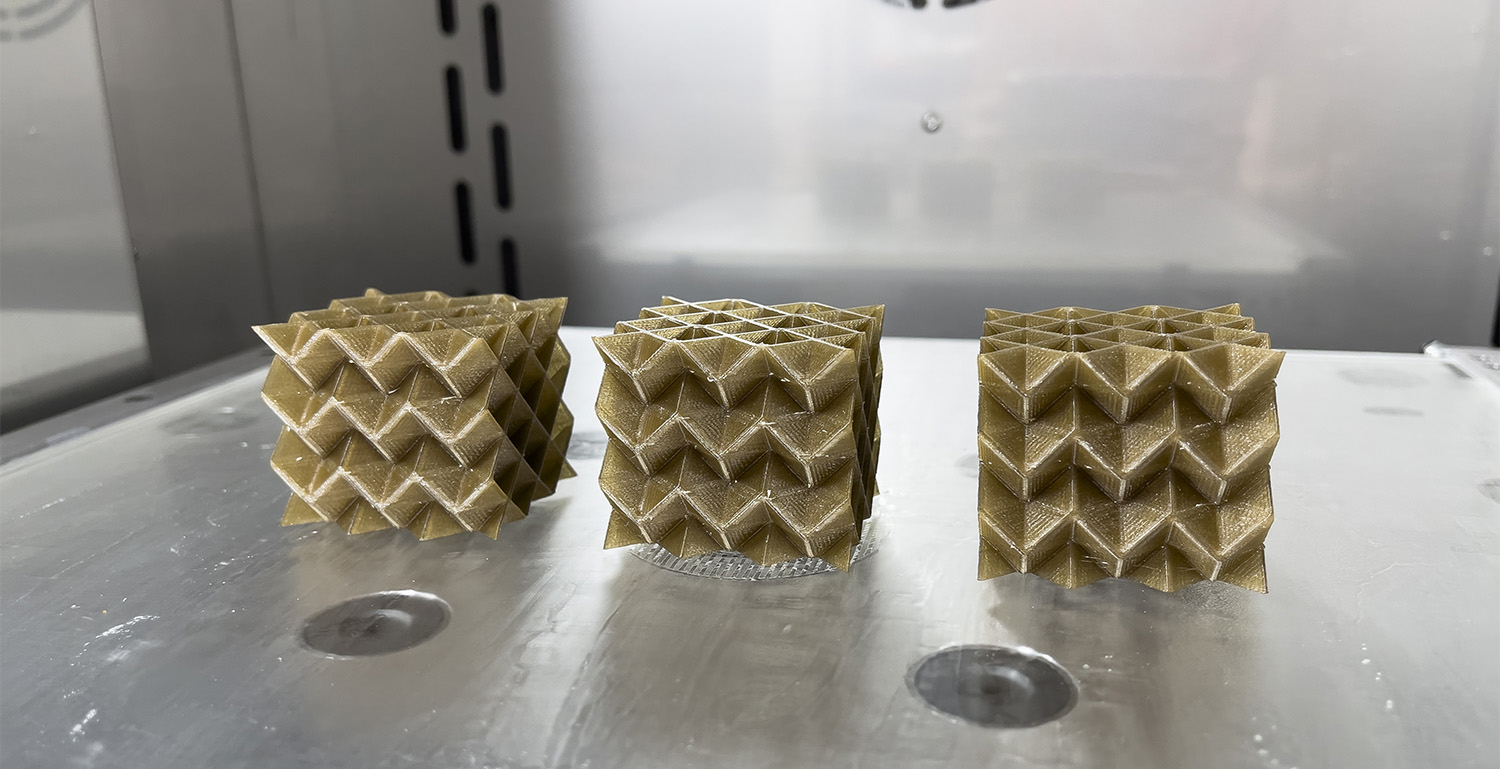 Three MetaCORE cubes made a PEEK sitting in the high-temperature 3D printer