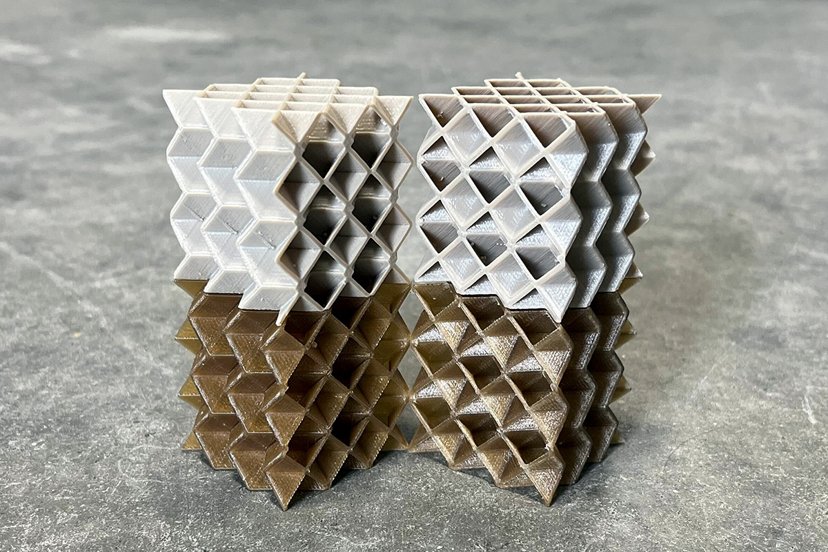 A set of four PEEK metamaterial cubes, two are pre- and two are post-annealed.