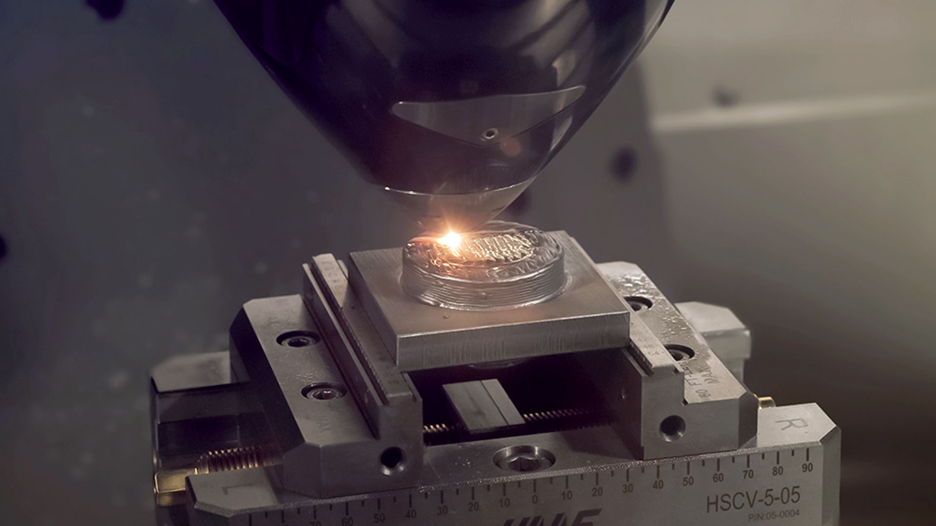 a functionally-graded sprue bushing being produced with wire-laser hybrid manufacturing