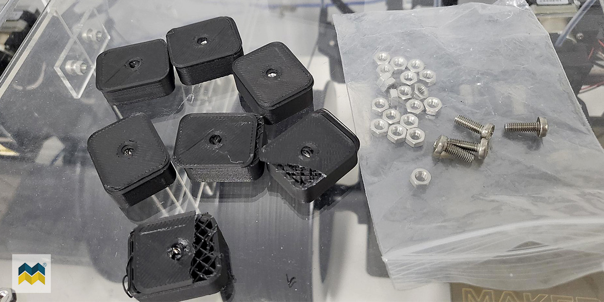 A collection of multiple trail-and-error captured metal 3D printing parts. Some are broken and show the origami composite structure within.